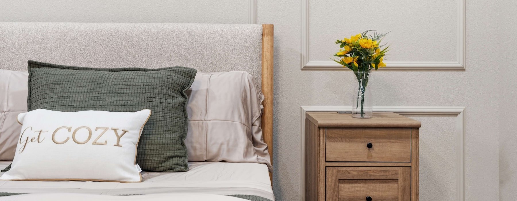 a bed with a flower on a nightstand